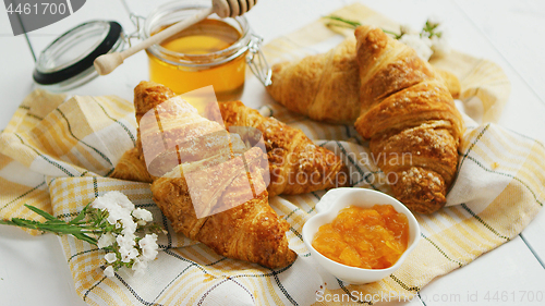 Image of Condiments and croissants lying on towel