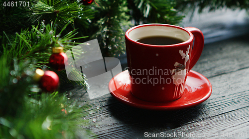 Image of Hot beverage near decorated conifer branches