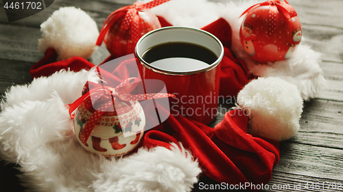 Image of Christmas hats and baubles around hot drink