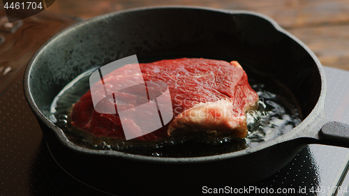 Image of Meat frying on pan