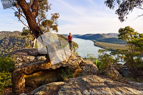 Image of Admiring the scenic river views high from a rocky cliff ledge