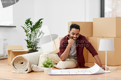 Image of man with boxes and blueprint moving to new home