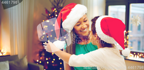 Image of happy mother and daughter on christmas