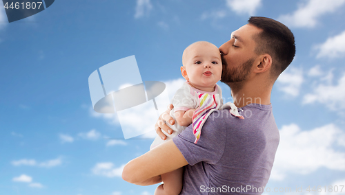 Image of father kissing little baby daughter