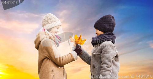 Image of kids with autumn maple leaves over sky background