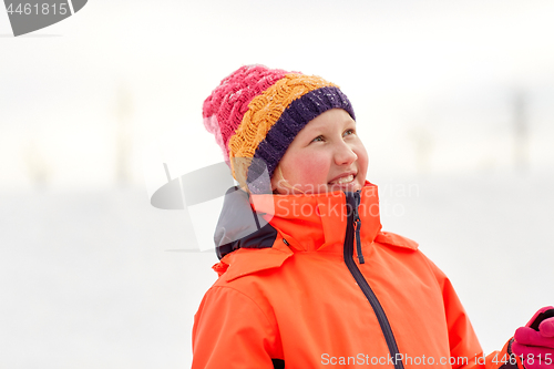 Image of happy little girl in winter clothes outdoors