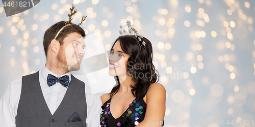 Image of couple with christmas or new year party props