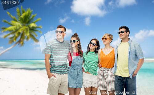 Image of friends in sunglasses over tropical beach