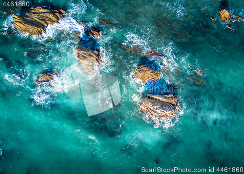 Image of Beautiful light in ocean surrounding coastal rocks in high tide