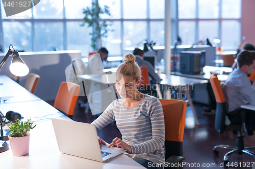 Image of businesswoman using a laptop in startup office