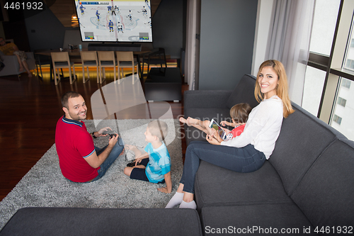 Image of Happy family playing a hockey video game
