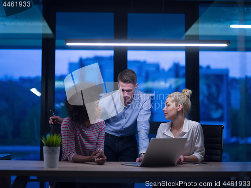 Image of Multiethnic startup business team in night office