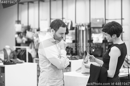 Image of couple chooses shoes At Shoe Store