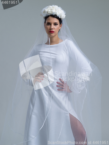 Image of young bride in a wedding dress with a veil