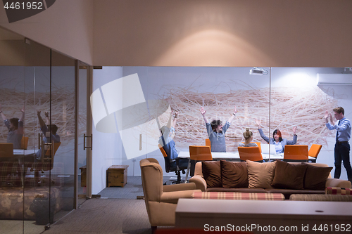 Image of Group of young business people throwing documents