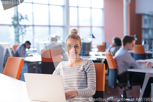 Image of businesswoman using a laptop in startup office