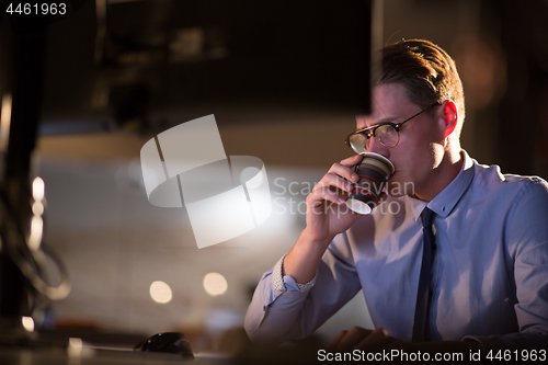 Image of Tired businessman working late