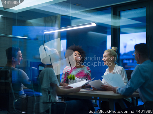 Image of Multiethnic startup business team in night office