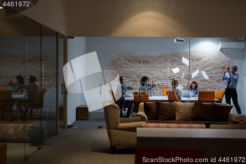 Image of Group of young business people throwing documents