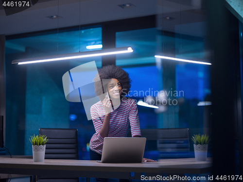 Image of black businesswoman using a laptop in startup office