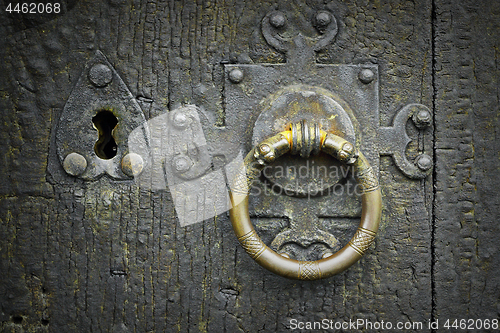 Image of old metalic latch on wooden door