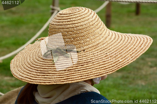 Image of Woman wearing a traditional straw hat 