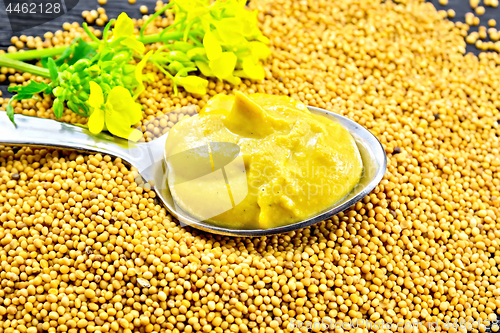Image of Sauce mustard in spoon with flower on seeds