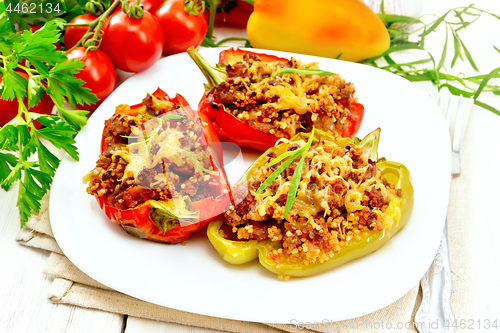 Image of Pepper stuffed with meat and couscous in plate on board