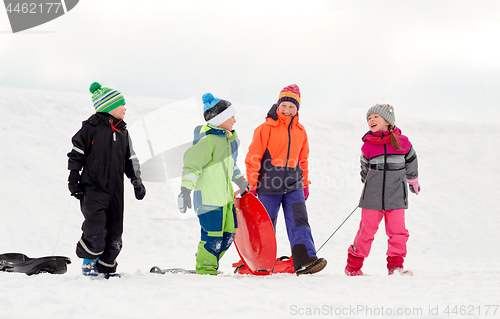 Image of happy little kids with sleds sledging in winter
