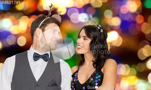 Image of couple with christmas or new year party props