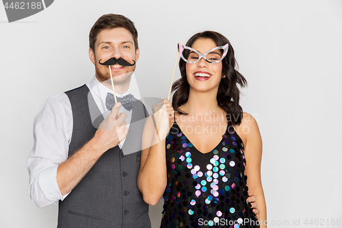 Image of happy couple with party props having fun