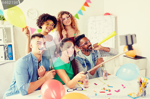 Image of happy team taking selfie at office party