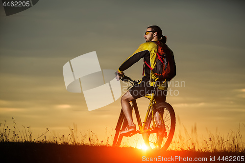 Image of Man in helmet and glasses stay on the bicycle