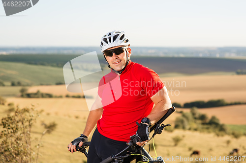 Image of Portrait of Young Cyclist in Helmet and Glasses