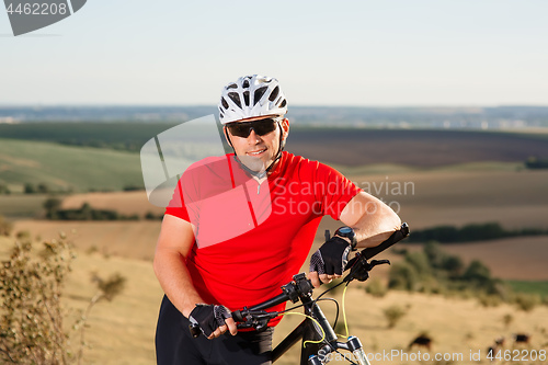 Image of Portrait of Young Cyclist in Helmet and Glasses