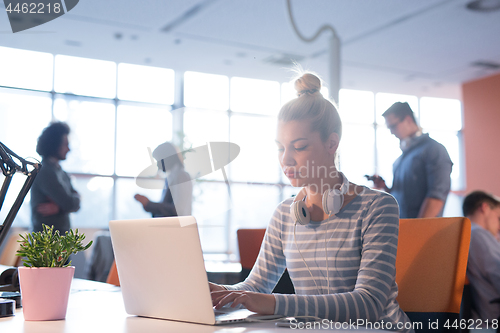 Image of businesswoman using a laptop in startup office