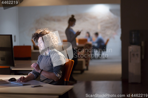 Image of man working on computer in dark office