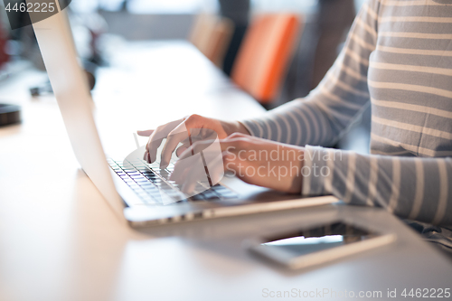 Image of businesswoman using a laptop in startup office