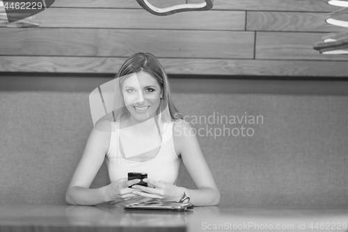 Image of young woman using mobile phone