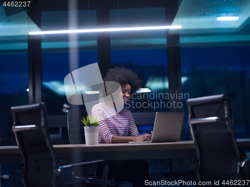 Image of black businesswoman using a laptop in startup office