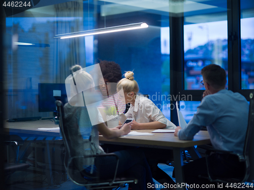 Image of Multiethnic startup business team in night office