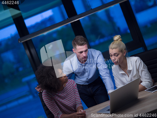 Image of Multiethnic startup business team in night office