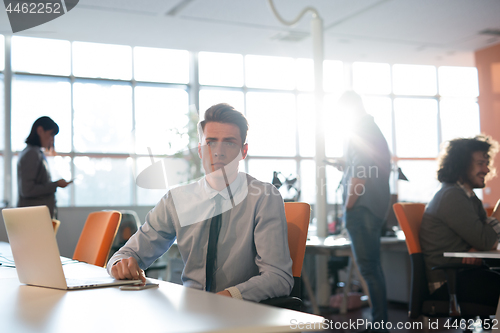 Image of businessman working using a laptop in startup office