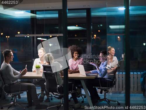 Image of Multiethnic startup business team in night office