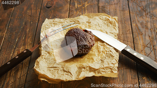 Image of Fork and knife near roasted meat