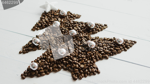 Image of Coffee beans laid in shape of fir