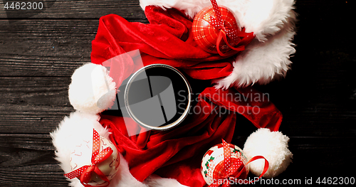 Image of Cup of coffee with Christmas hats around 