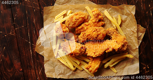 Image of Fried meat and potatoes on paper