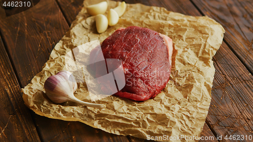 Image of Garlic and meat on parchment
