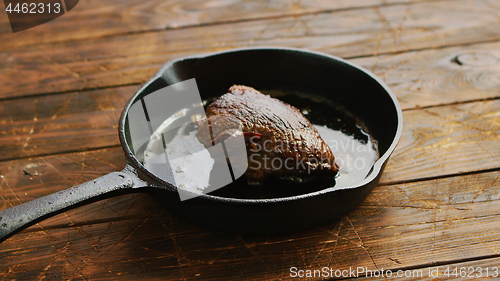 Image of Meat and oil on skillet